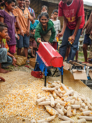 These farmers in Indonesia used to remove corn kernels by hand. Village Infrastructure Angel's solar-powered mill speeds up the process.