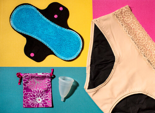 New products include a reusable pad made of fleece, a pair of THINX underwear and a DivaCup with carrying case. (Meredith Rizzo/NPR)