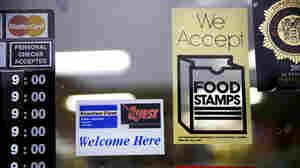 A supermarket displays stickers indicating it accepts food stamps in West New York, N.J., in January 2015.