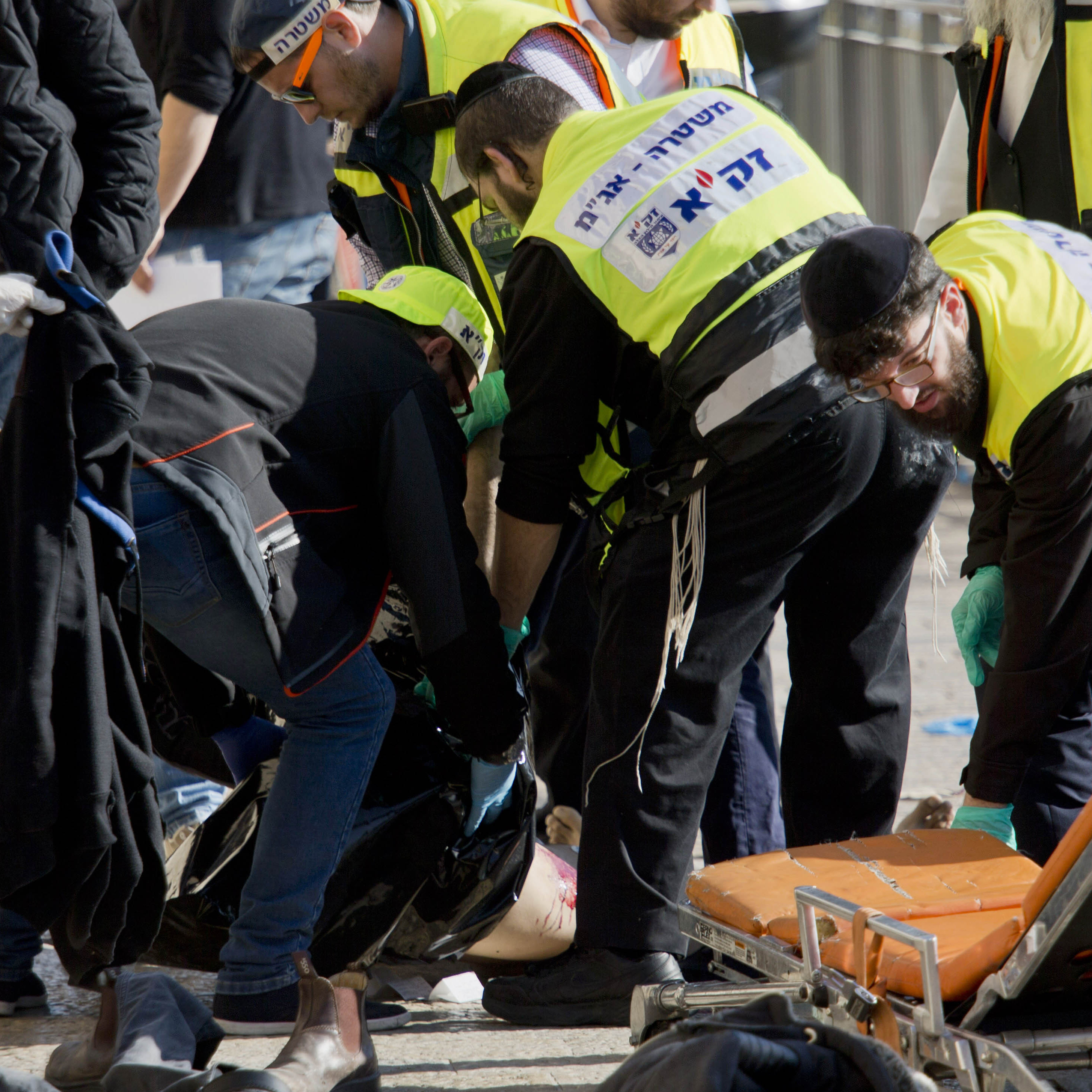 Israeli officers evacuate the body of a Palestinian assailant from the site of a stabbing attack outside Jerusalem's Old City on Dec. 23. For more than three months, Jerusalem has seen near-daily Palestinian attacks on Israelis.