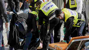 Israeli officers evacuate the body of a Palestinian assailant from the site of a stabbing attack outside Jerusalem's Old City on Dec. 23. For more than three months, Jerusalem has seen near-daily Palestinian attacks on Israelis.