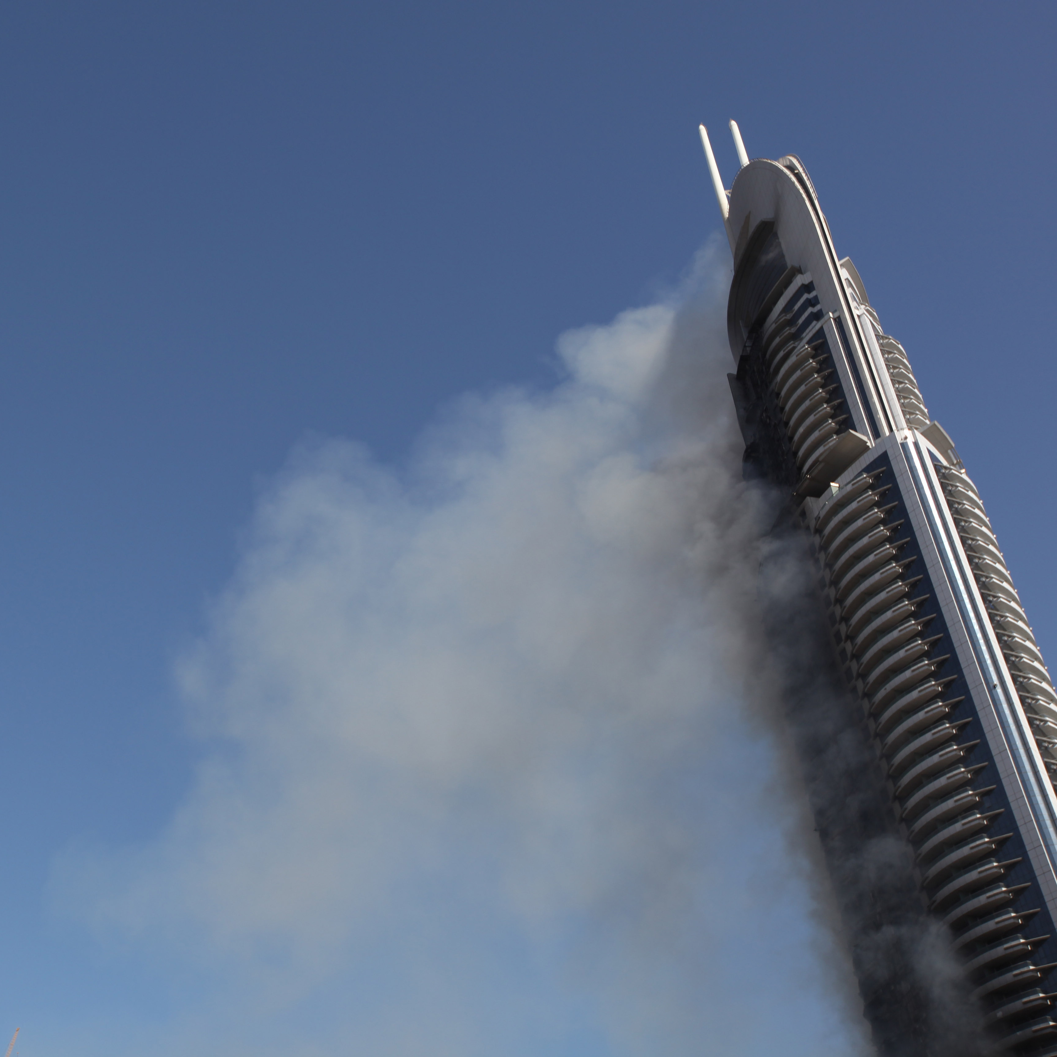 Smoke billows from the Address Downtown skyscraper in Dubai, United Arab Emirates on Friday, Jan. 1, 2016.