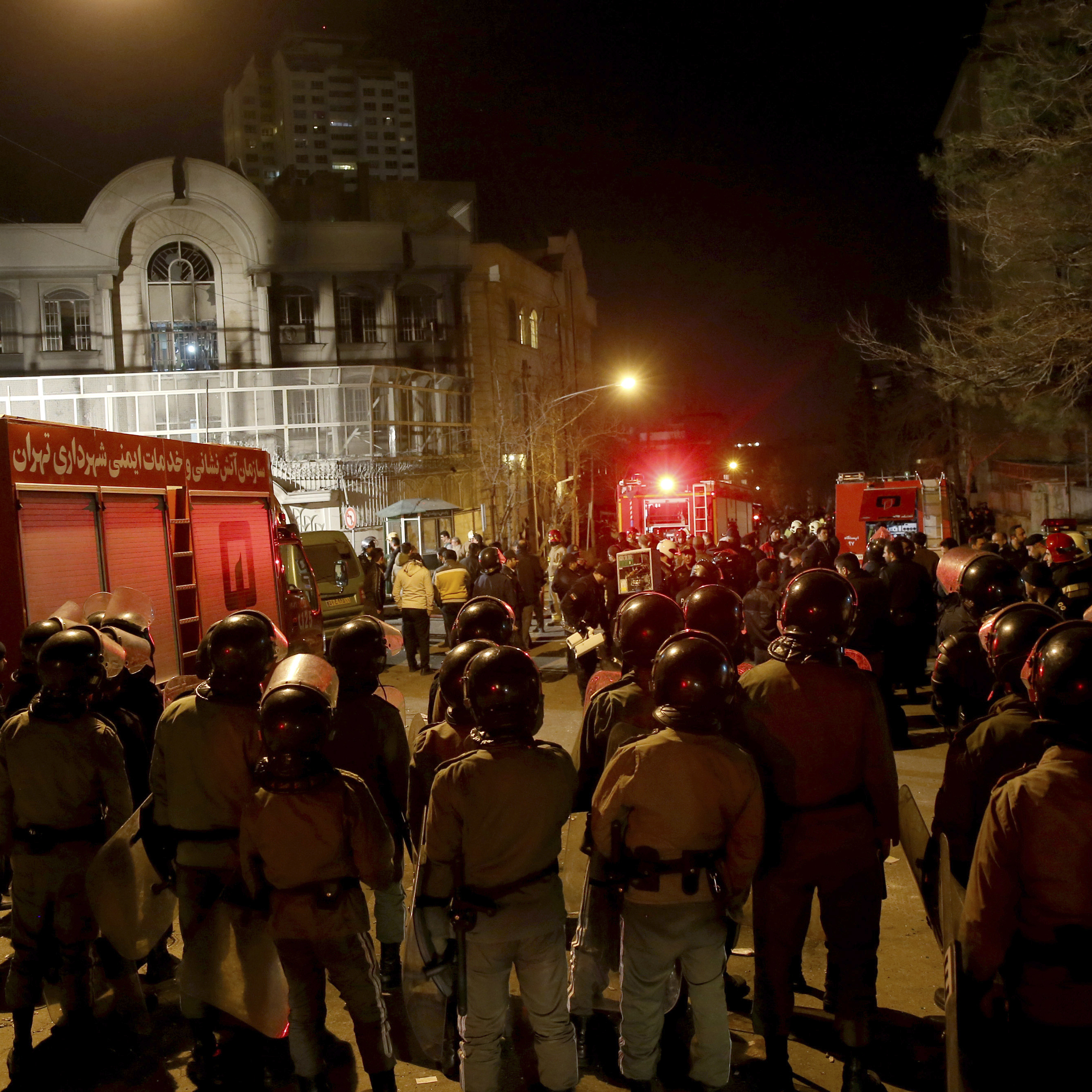 Iranian security stand guard to protect Saudi Arabia's embassy in Tehran, Iran, while a group of demonstrators gathered to protest execution of a Shiite cleric in Saudi Arabia late Saturday into early Sunday.