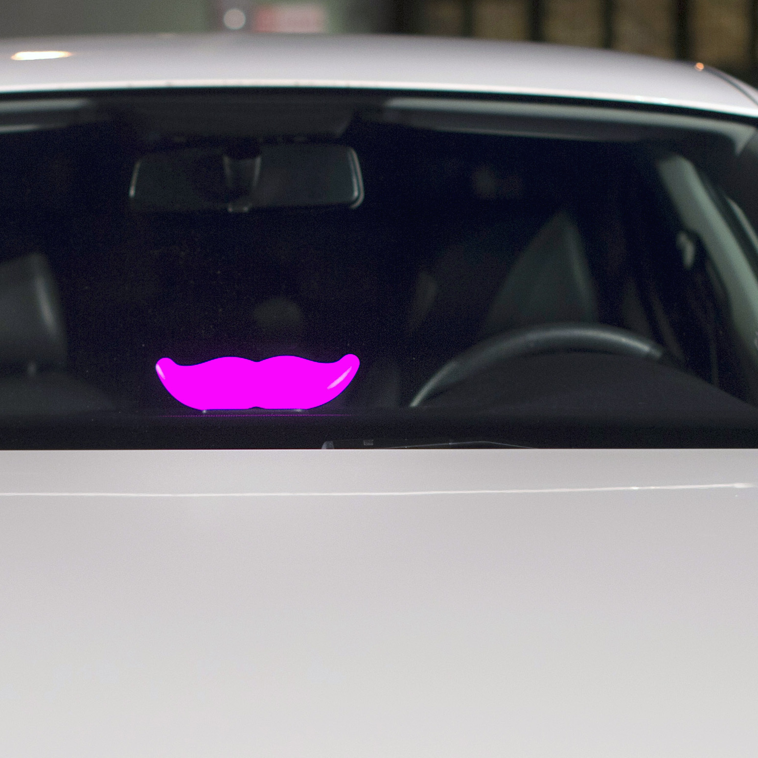 A Lyft "glowstache" rests on a dashboard of a car at the company's San Francisco headquarters.