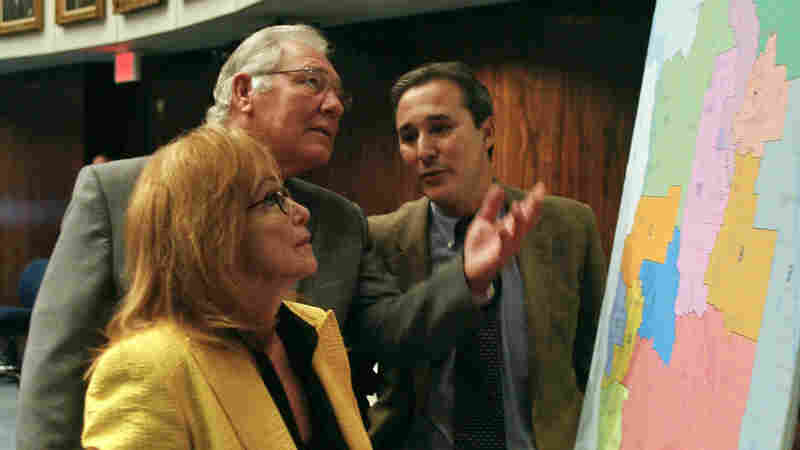 Florida state Sens. (from left) Eleanor Sobel, Greg Evers and Rene Garcia discuss a congressional redistricting map on the floor of the Senate in 2014.