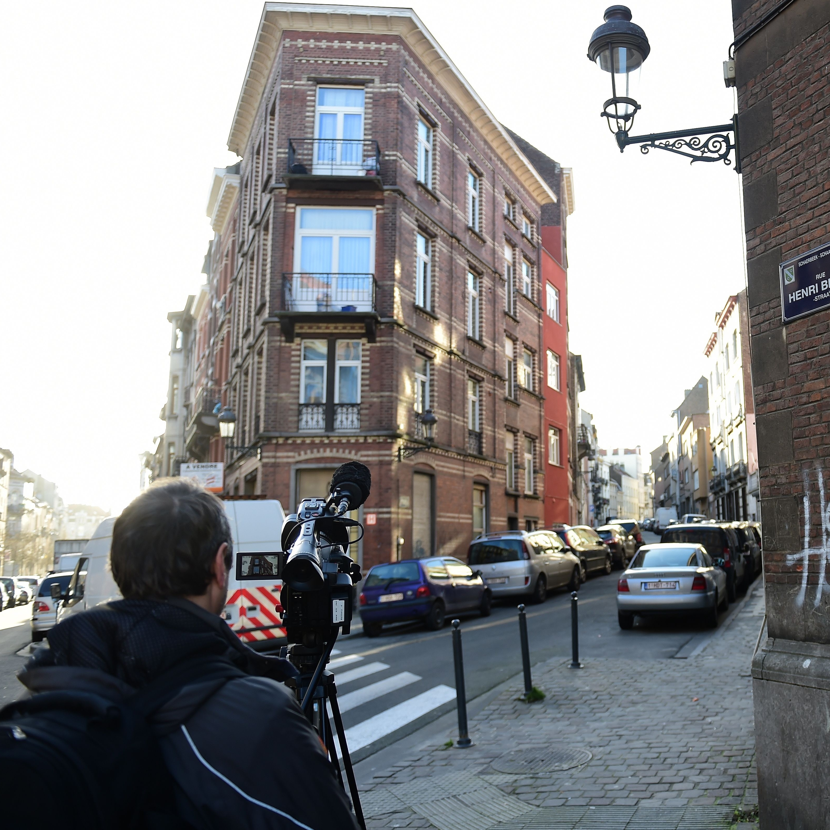Journalists descended on a street in the Brussels district of Schaerbeek, where police found three belts for possible use in suicide attacks, traces of explosives and a fingerprint of wanted Paris attacks suspect Salah Abdeslam.
