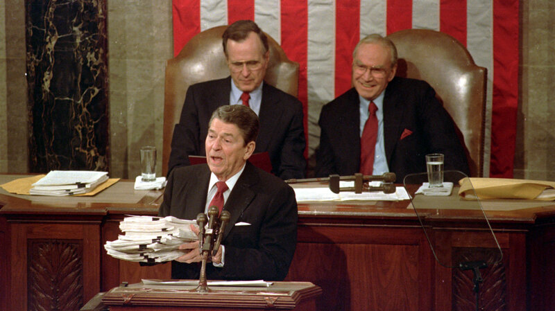 In 1988, President Ronald Reagan held up a 14-pound continuing resolution for the budget, part of a total package weighing 43-pounds. (Bob Daugherty /AP)