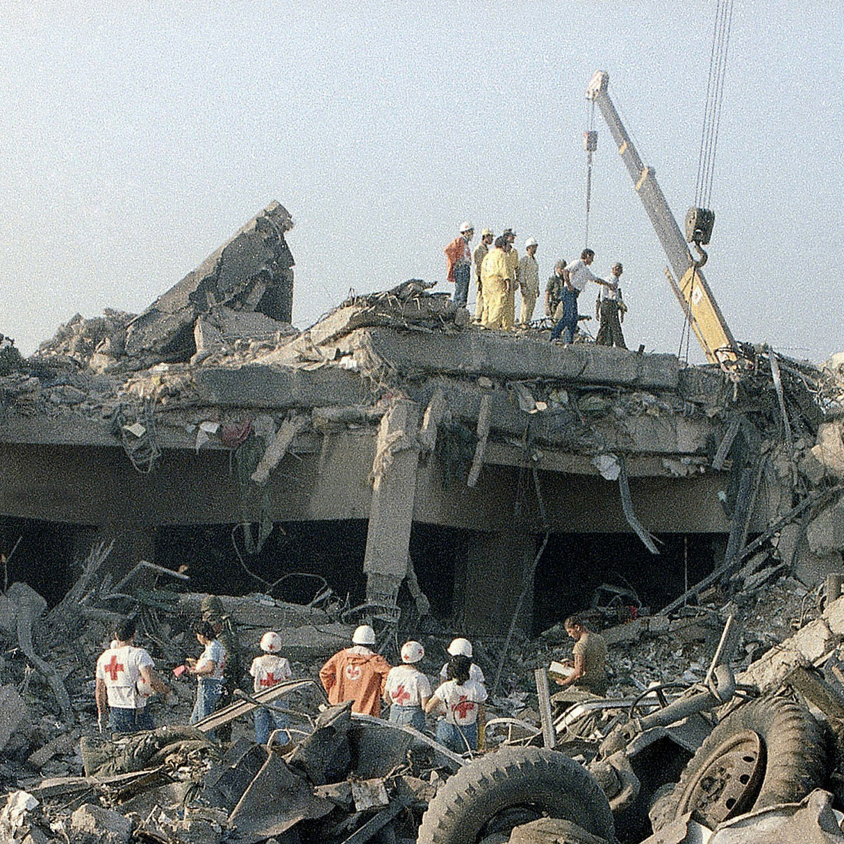 Rescuers search through the rubble of the U.S. Marine barracks Oct. 23, 1983, in Beirut, Lebanon, after a suicide truck bombing. The blast — the single deadliest attack on U.S. forces abroad since World War II — killed 241 American service members. The Supreme Court is deciding whether Congress can pass a law compensating the victims, and those of other attacks, using Iranian government funds.
