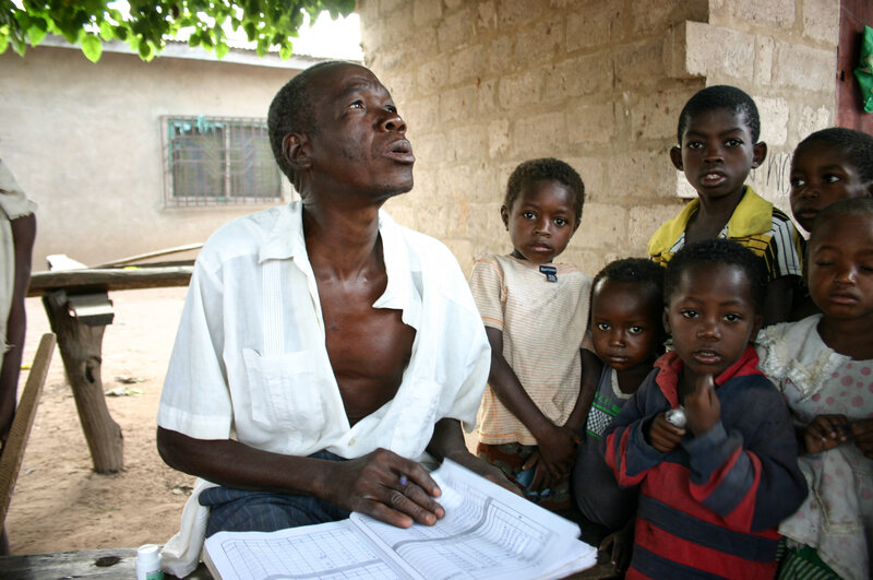 Albert Tamanja Bidim, a community volunteer, distributes ivermectin, the tablet that fights river blindness, in the Ghanaian town of Beposo 2. (Jason Beaubien/NPR)