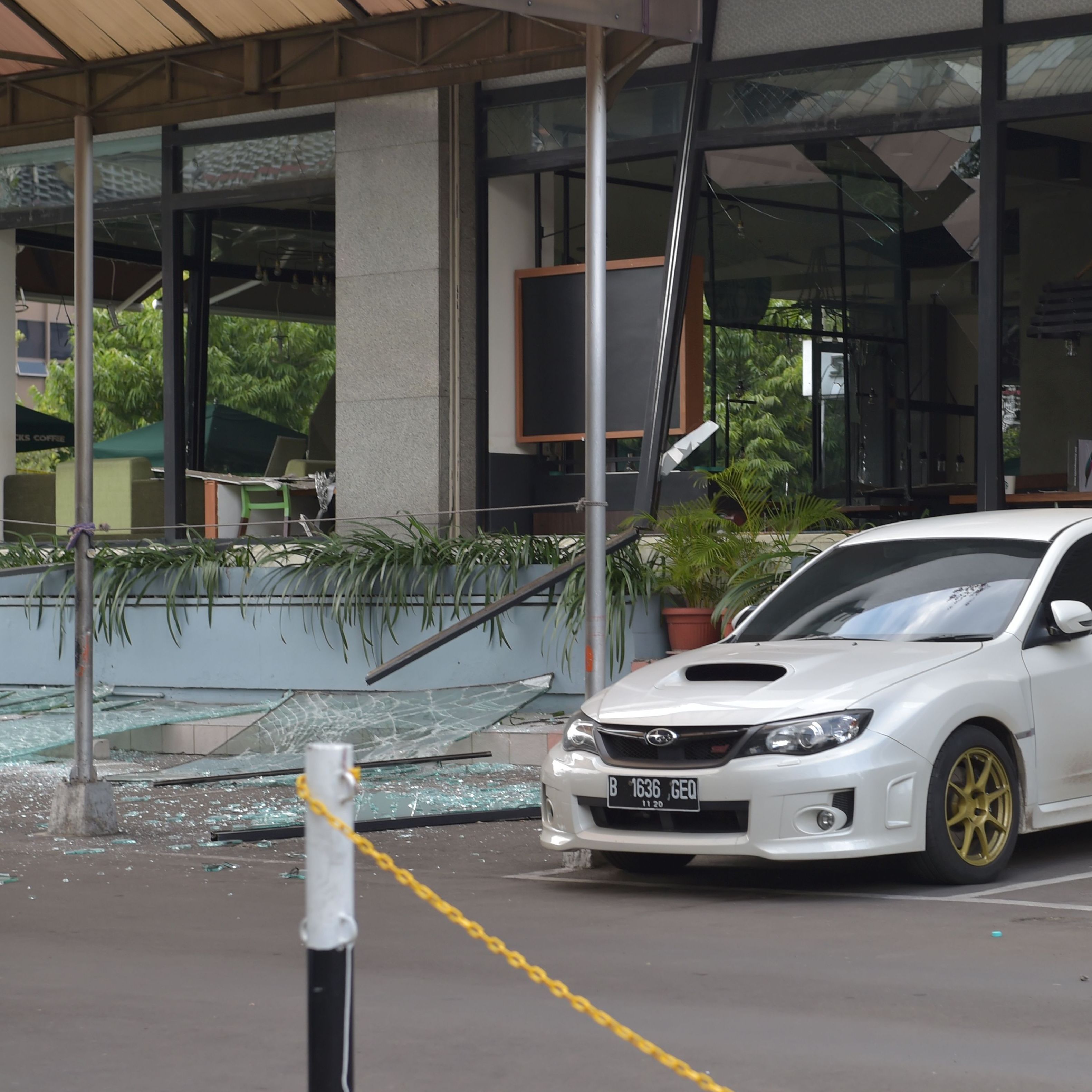 A damaged Starbucks coffee shop is seen in central Jakarta, after a series of explosions hit a popular shopping area Thursday.