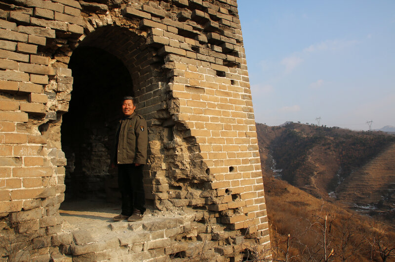 Qiao Guohua, a resident of Jielingkou village, is paid a small sum of money by the local government to patrol a section of the Great Wall. He's come to know every feature of the wall and its surrounding landscape intimately. (Anthony Kuhn/NPR) Qiao Guohua, a resident of Jielingkou village, is paid a small sum of money by the local government to patrol a section of the Great Wall. He's come to know every feature of the wall and its surrounding landscape intimately.