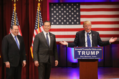 Donald Trump (right) brings the two most recent Iowa winners, Mike Huckabee (left) and Rick Santorum, on stage during Trump's rally for veterans, an event he held instead of attending the GOP debate. Donald Trump (right) brings the two most recent Iowa winners, Mike Huckabee (left) and Rick Santorum, on stage during Trump's rally for veterans, an event he held instead of attending the GOP debate.