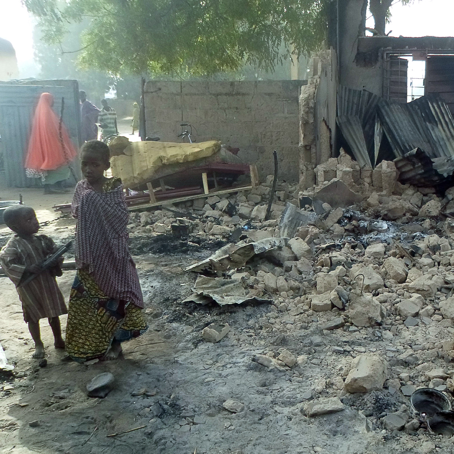 Children stand near the rubble of a burnt house after Boko Haram attacks at Dalori, in northeastern Nigeria, on Sunday.