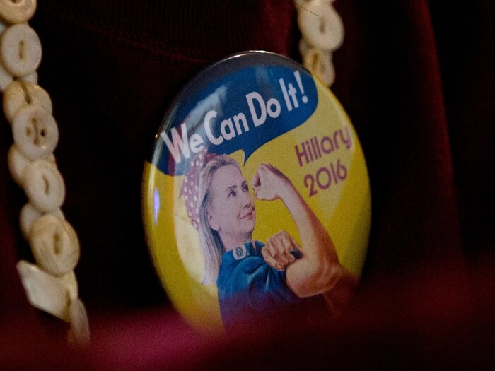 A woman wears a campaign button in the vein of Rosie the Riveter to a Hillary Clinton event in Davenport, Iowa.