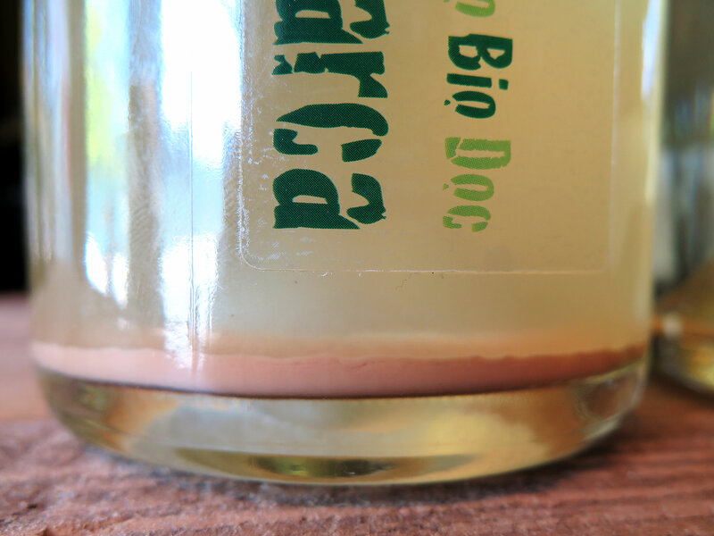 A close-up of Terre di Marca, a natural Prosecco from Italy sold at the Passage de la Fleur wine shop in Brooklyn, N.Y. The wine is unfiltered, and the sediment collected in the bottle's bottom is yeast. (Andrea Shea for NPR)