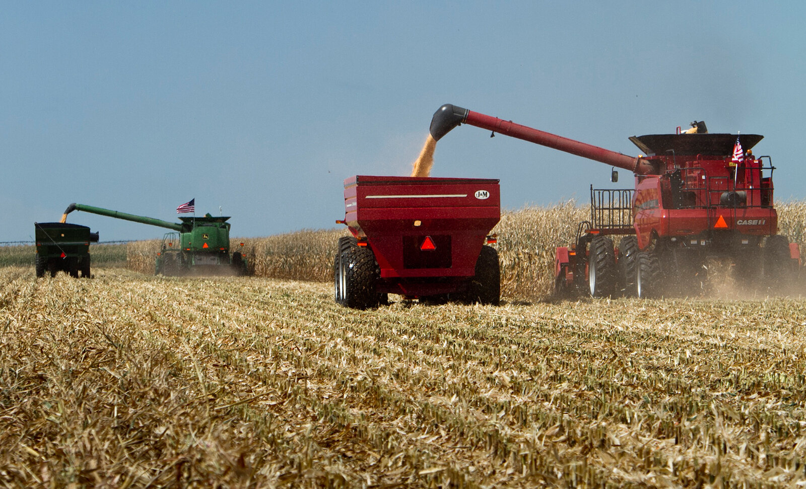Combines harvest a corn field in Grand Island, Neb.