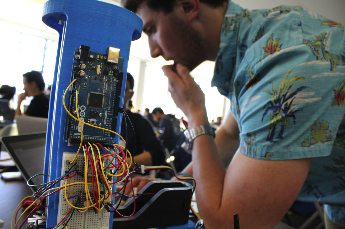 David Kaplan, a University of Maryland, College Park sophomore, tinkers with a robotic arm programmed to play tic-tac-toe at the Georgetown Hackathon in Washington, D.C. David Kaplan, a University of Maryland, College Park sophomore, tinkers with a robotic arm programmed to play tic-tac-toe at the Georgetown Hackathon in Washington, D.C.