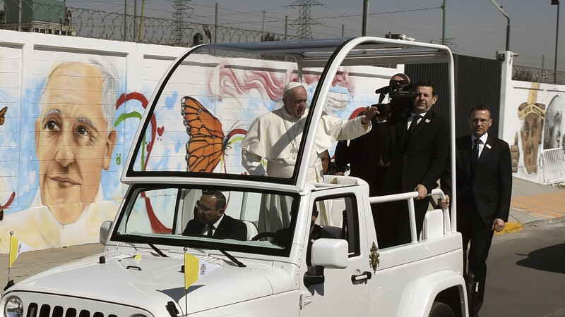 Pope Francis waves from the popemobile upon arrival in Ecatepec — a rough, crime-plagued Mexico City suburb — on Sunday. Pope Francis has chosen to visit some of Mexico's most troubled regions during his five-day trip to the country. (Yuri Cortez/AFP/Getty Images)