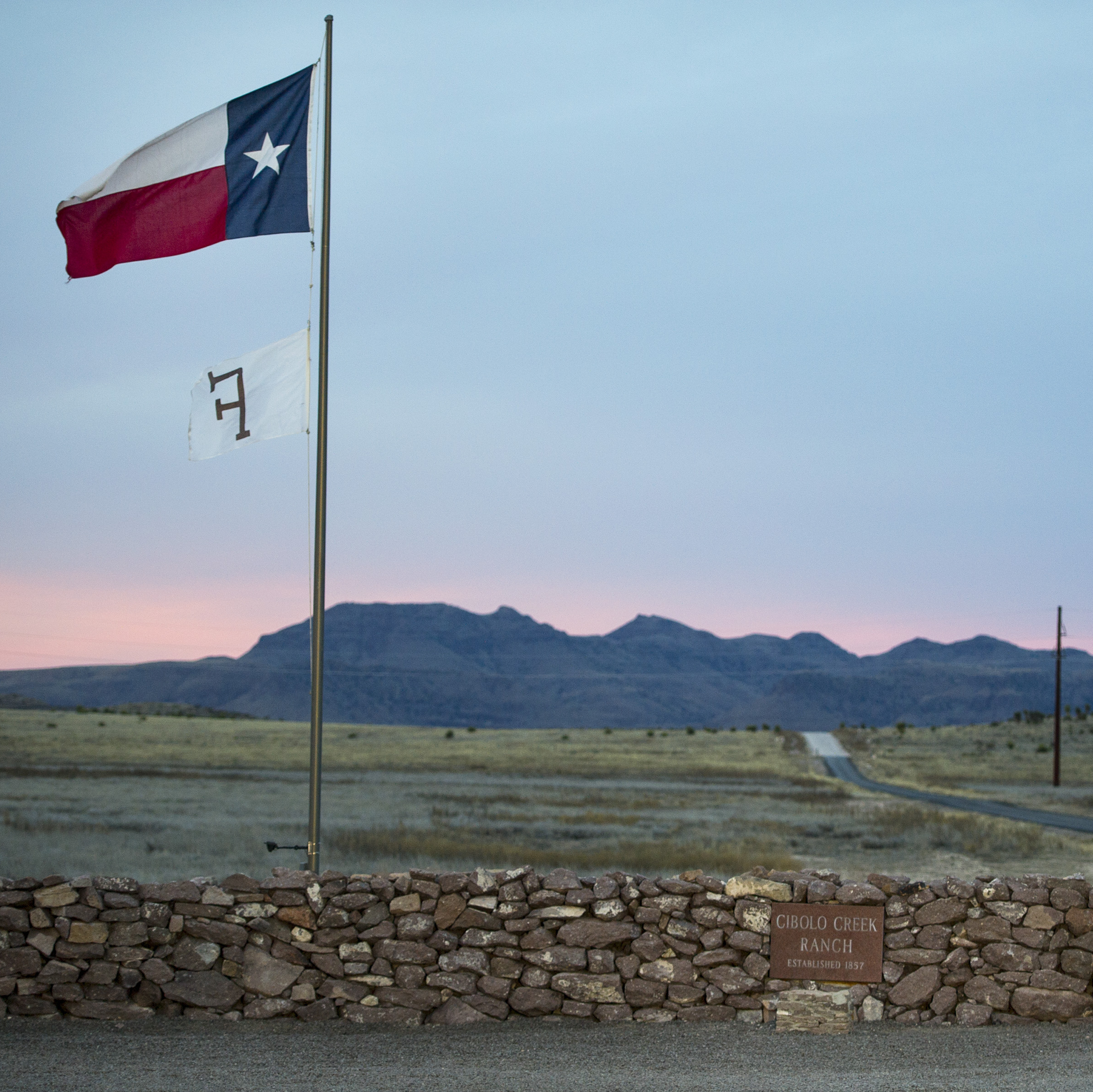 The Texas flag flies at the entrance to the Cibolo Creek Ranch on Sunday, the day after Supreme Court Justice Antonin Scalia was found dead there.