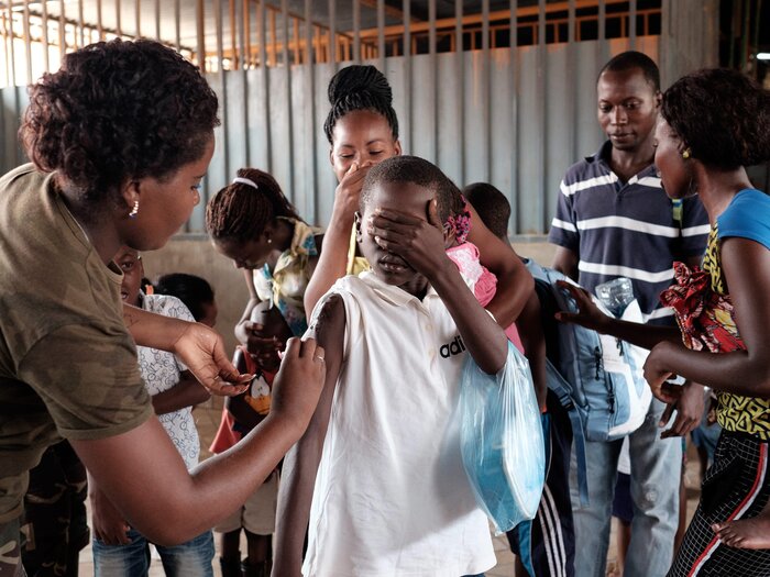 The Angolan military administers yellow fever vaccines at a market in Luanda, the capital city. The Angolan military administers yellow fever vaccines at a market in Luanda, the capital city.
