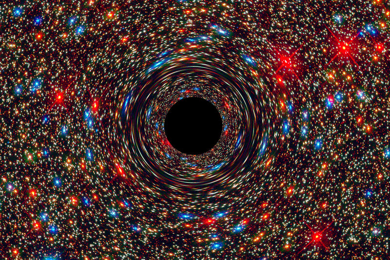 This computer-simulated image shows a supermassive black hole at the core of a galaxy. The cosmic monster's powerful gravity distorts space around it like the mirror in a fun house, smearing the light from nearby stars.