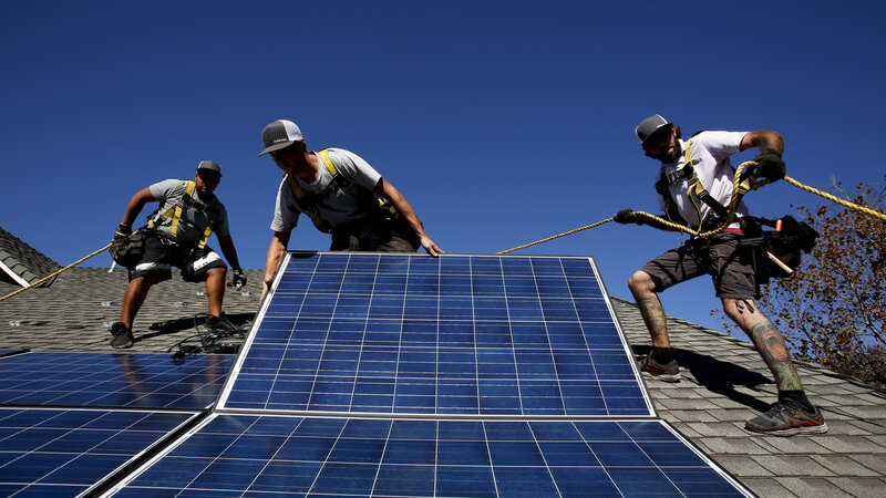 Workers install solar panels on the roof of a home in Camarillo, Calif., in 2013. San Francisco has recently decided to start requiring rooftop solar systems — electrical or heating — on new construction up to 10 stories tall.