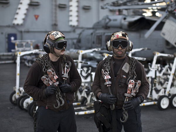 U.S. Navy air wing captains pause on the flight deck of the aircraft carrier USS Theodore Roosevelt last September. Every day, the steam-powered catapult aboard this massive ship flings American fighter jets into the sky, on missions to target the extremist Islamic State group in Iraq and Syria. U.S. Navy air wing captains pause on the flight deck of the aircraft carrier USS Theodore Roosevelt last September. Every day, the steam-powered catapult aboard this massive ship flings American fighter jets into the sky, on missions to target the extremist Islamic State group in Iraq and Syria.