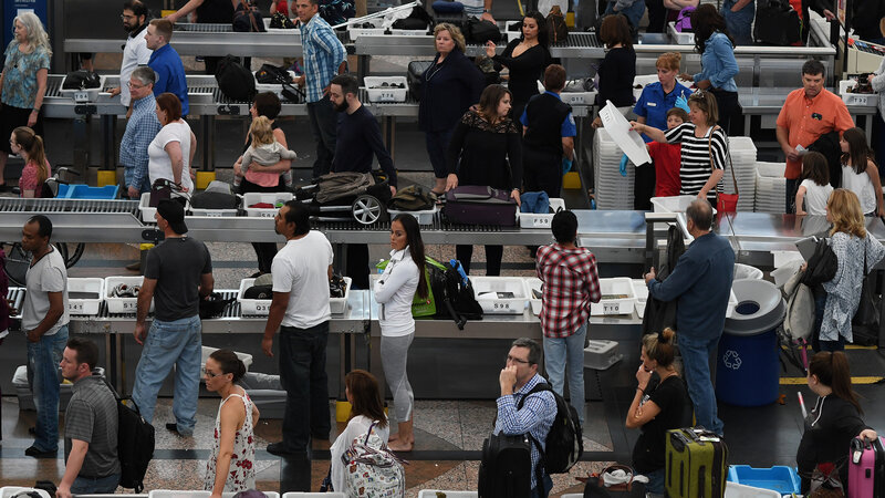 Lines of travelers at Denver International Airport snake their way through security on Thursday. Lines of travelers at Denver International Airport snake their way through security on Thursday.