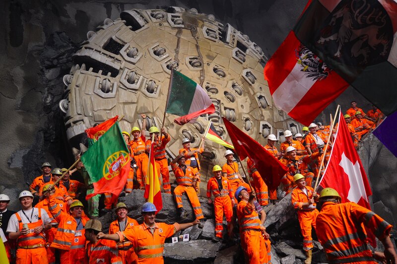 Miners celebrate beneath the Swiss Alps in 2010, after a giant drilling machine bored through to create the world's longest tunnel. After several more years of work, the train line through that tunnel is now open. Miners celebrate beneath the Swiss Alps in 2010, after a giant drilling machine bored through to create the world's longest tunnel. After several more years of work, the train line through that tunnel is now open.