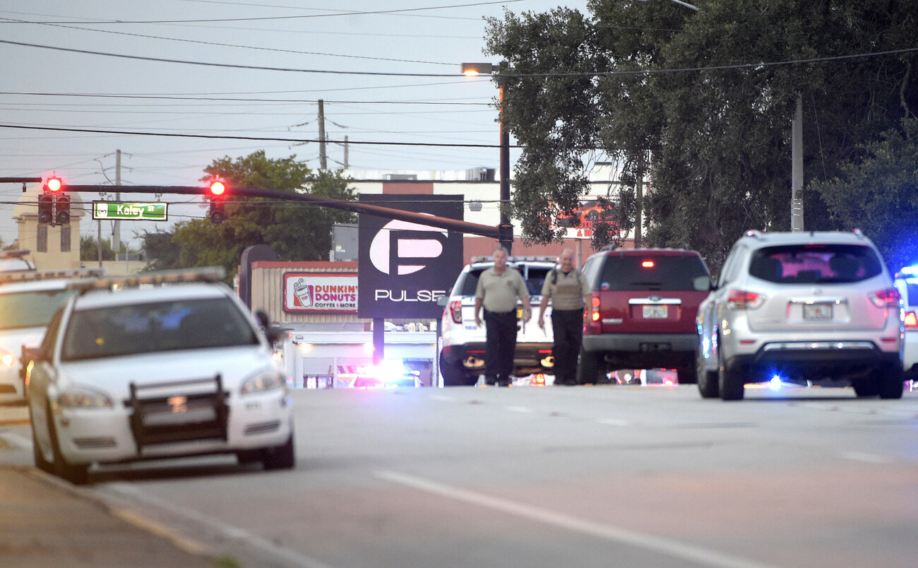 Police cars surround the Pulse Orlando nightclub, the scene of a fatal shooting, in Orlando, Fla. Police cars surround the Pulse Orlando nightclub, the scene of a fatal shooting, in Orlando, Fla.