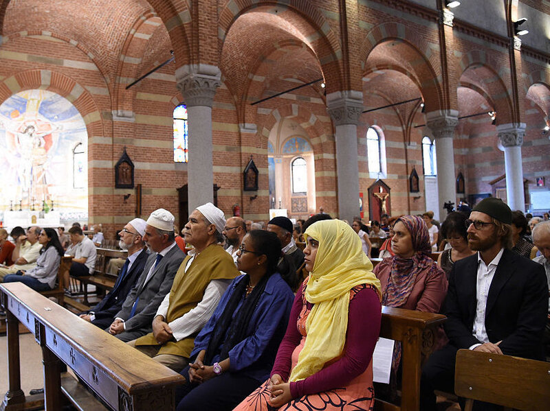 Members of the Muslim community attend a mass in the Catholic church of Santa Maria of Caravaggio on Sunday in Milan, Italy.