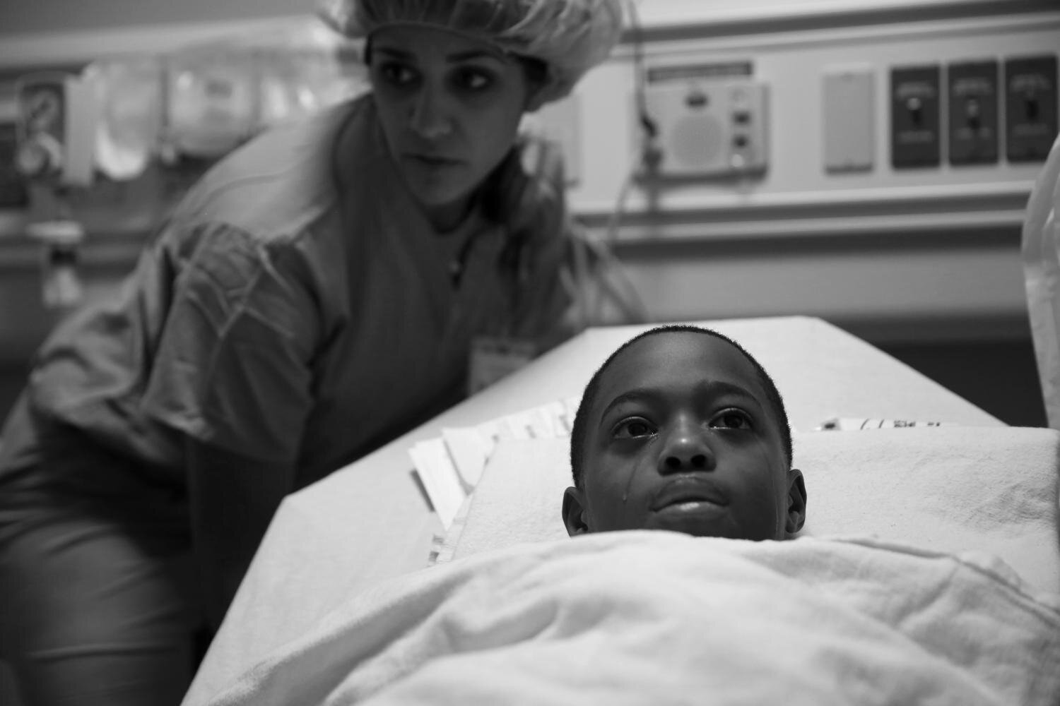 Tavon Tanner tears up before surgery at Lurie Children's Hospital on Oct. 17 to remove the bullet that ripped through his pancreas, stomach, spleen, a kidney and his left lung before becoming lodged just below his shoulder.
(E. Jason Wambsgans/Chicago Tribune/Courtesy of Columbia University)