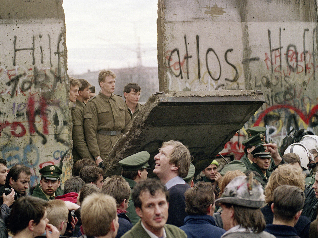 West Berliners crowd in front of the Berlin Wall on Nov. 11, 1989, as they watch East German border guards demolishing a section of the wall in order to open a new crossing point between East and West Berlin. (Gerard Malie /AFP/Getty Images)