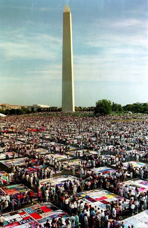 Thousands of people gather to view the AIDS Memorial Quilt on display on the Washington Monument grounds on Oct. 10, 1992. The quilt contains more than 20,000 panels with the names of people who have died of AIDS. (Renaud Giroux /AFP/Getty Images)