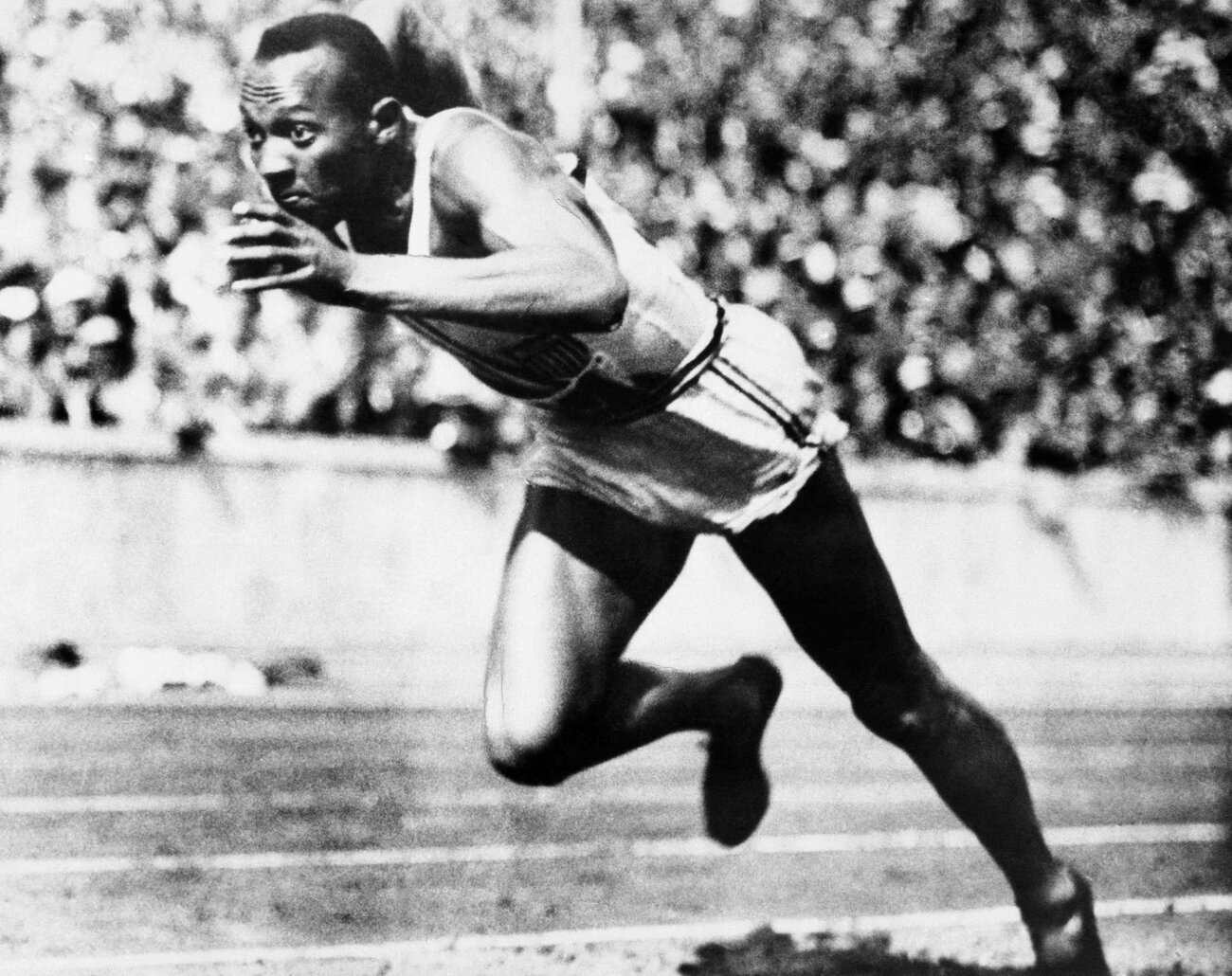 Jesse Owens competing in one of the heats of the 200-meter run at the 1936 Olympic Games in Berlin. Owens won four gold medals at games in front of Hitler. (AP)