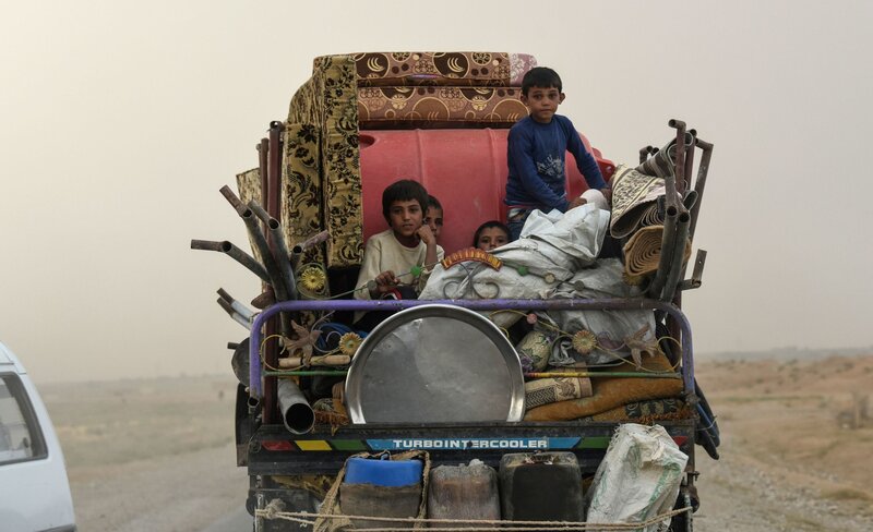 Displaced Syrians head to refugee camps on the outskirts of Raqqa on Sunday. Syrian fighters, backed by the U.S., have been driving out the Islamic State. However, many civilians are fleeing the fighting, and there's still no sign of a political settlement in Syria on the horizon. (Bulent Kilic /AFP/Getty Images)