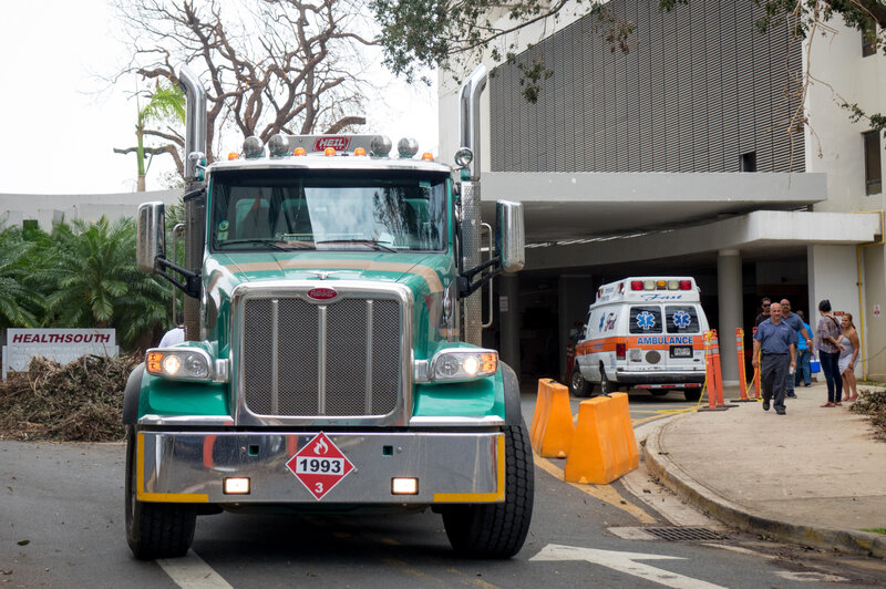 A truck hauling diesel leaves the University of Puerto Rico's Medical Center, which is operating on diesel-powered generators following Hurricane Maria. (Angel Valentin for NPR)