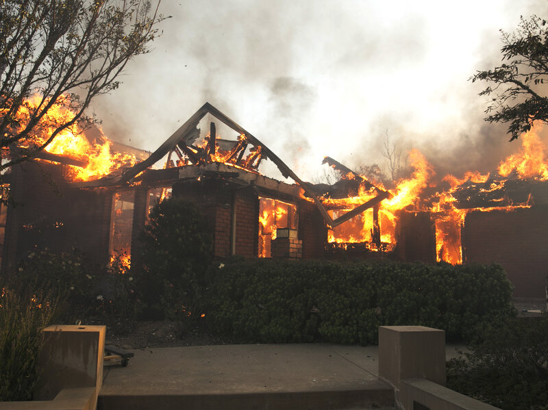 Flames from a wildfire consume a home Monday, east of Napa, Calif.
(Rich Pedroncelli/AP)