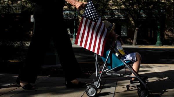 A child rides in a stroller during a rally in El Paso, Texas Thursday to protest the Trump administration