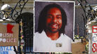 A photo of Philando Castile is attached to the gate of the governor's residence in St. Paul, Minn., part of a memorial to the Minnesota man, who was shot and killed by a police officer in July 2016.