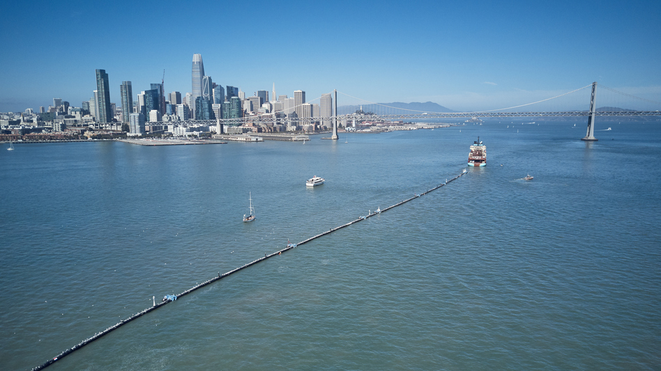 A nearly 2,000-foot-long tube is towed offshore from San Francisco Bay on Saturday. It's a giant garbage collector and the brainchild of 24-year-old Boyan Slat, who aims to remove 90 percent of ocean plastic by 2040.