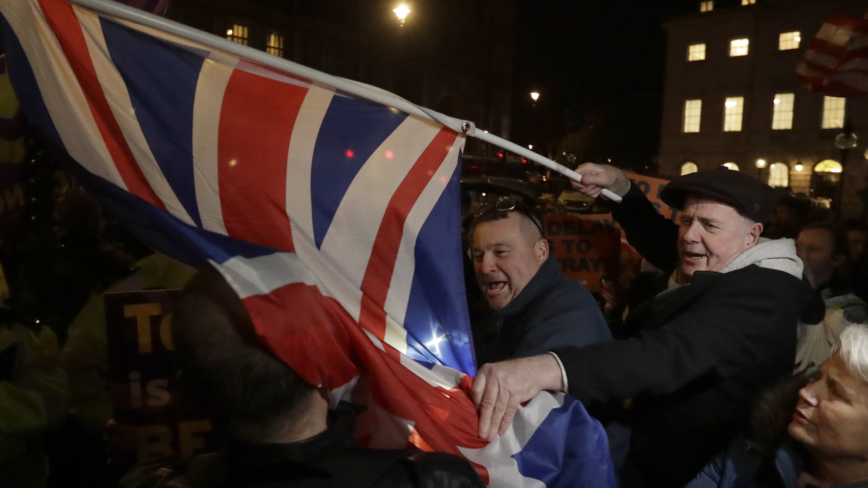 Brexit supporters and opponents shout at each other outside Parliament in London on Thursday the day that British lawmakers voted to delay Brexit