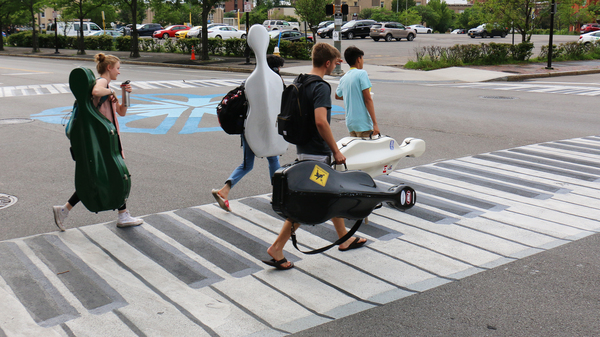 Musicians walk on a crosswalk painted like a piano Outside the Eastman School of Music in Rochester, N.Y. Increasingly, urban designers and transportation planners say this kind of art â colorful crosswalks and engaging sidewalks â leads to safer intersections, stronger neighborhoods, and better public health.