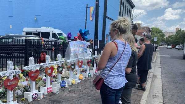 Onlookers in Dayton mourn the nine people who died when a gunman opened fire in a crowd outside a popular bar in the city