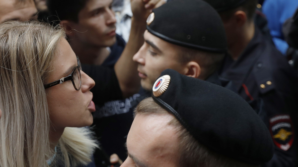 Russian opposition candidate and lawyer Lyubov Sobol stands in front of police during a demonstration in Moscow, on July 14. This summer