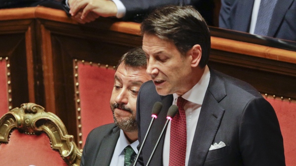 Italian Premier Giuseppe Conte (right) speaks to the Senate on Tuesday next to Deputy Premier Matteo Salvini.