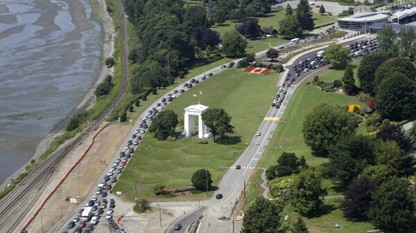 Cars line-up heading into the United States at left and into Canada at right adjacent to Boundary Bay at a border crossing at Blaine, Wash., in July 2009. U.S. Customs and Border Protection agents arrested a British couple who say they accidentally crossed the U.S.-Canada border.