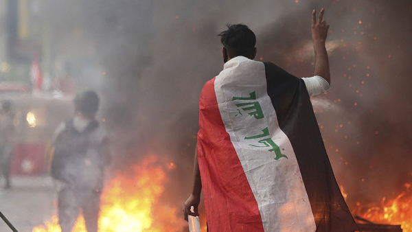 Anti-government protesters set fire and close streets during ongoing protests in Baghdad, Iraq on Saturday.