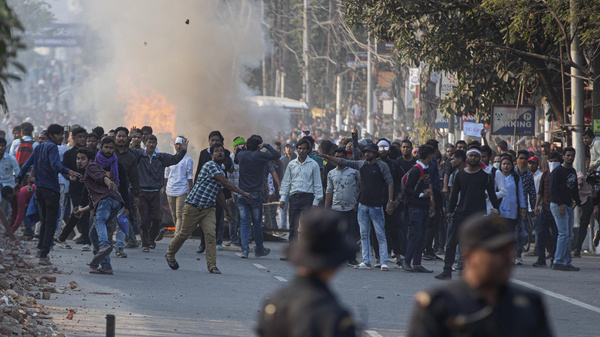 Protesters throw stones at security officers during a protest against the Citizenship Amendment Bill in Gauhati, India, on Wednesday.