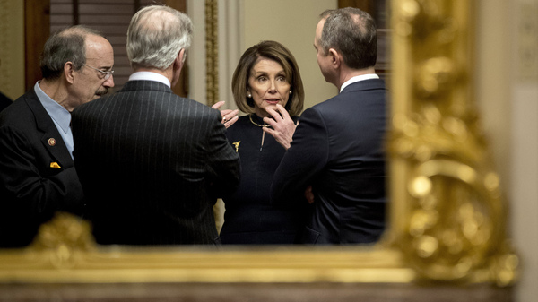 House Speaker Nancy Pelosi, center, speaks with House Intelligence Committee Chairman Adam Schiff, right, House Foreign Affairs Committee Chairman Eliot Engel, left, and House Ways and Means Committee Chairman Richard Neal after the House voted to impeach President Trump on Dec. 18.